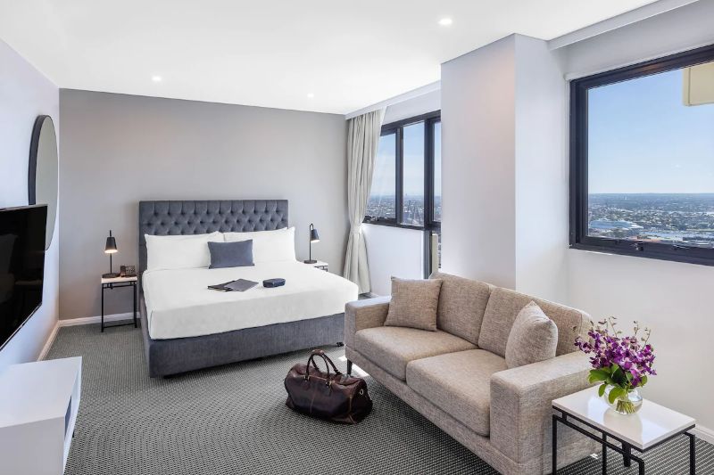 Meriton Suites Kent room with bed and sofa