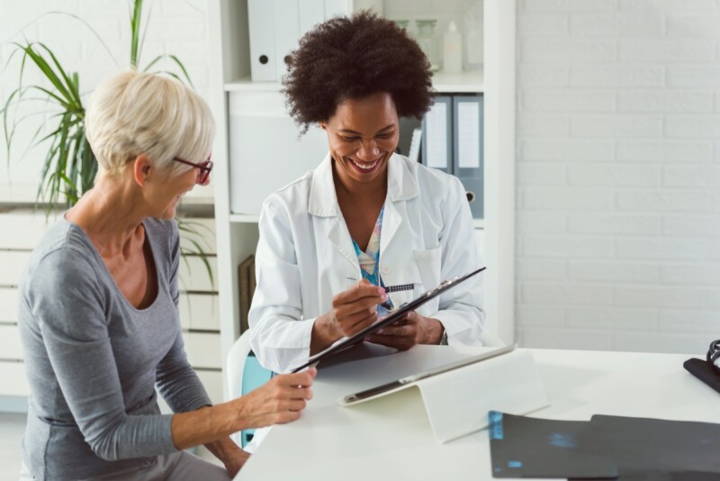 Female doctor health professional talking to a patient