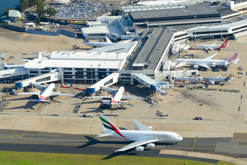 Sydney Airport aerial view with international Passengers Terminal 1 busy with international flights. Kingsford Smith International Airport, Australia