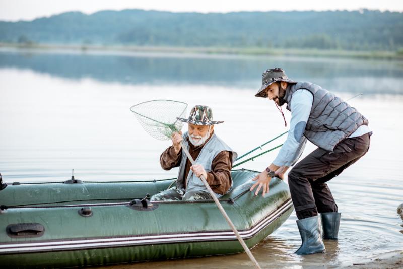 Father and son fishing from a boat