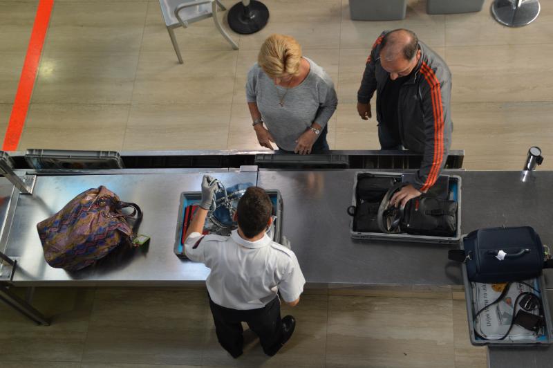 Couple with their baggage being checked