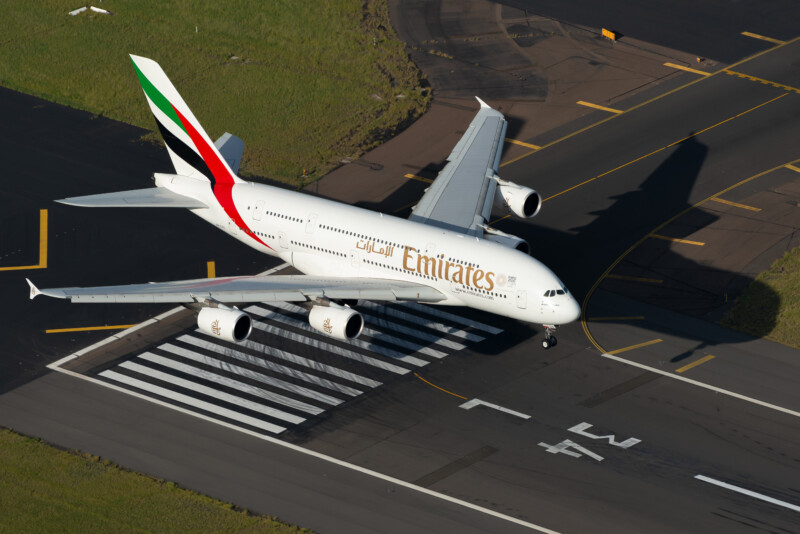 Emirates Airlines Airbus A380 aircraft over Sydney International Airport runway