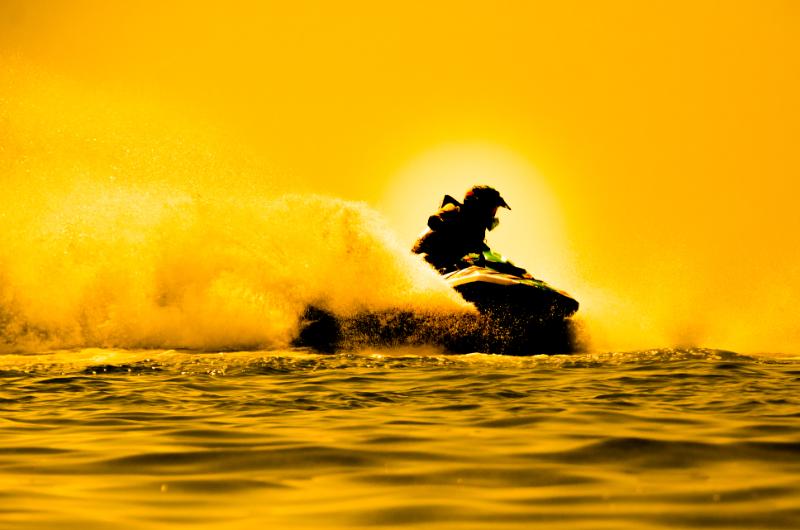 Man driving jetski during sundown