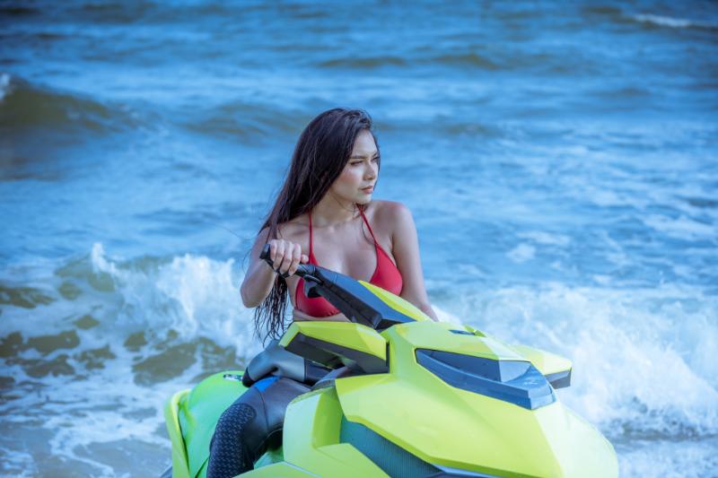 Sexy lady on the beach on a jetski