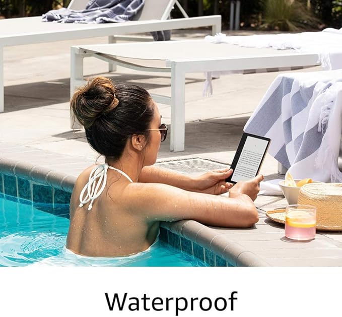 Woman reading ebook from Kindle Oasis at a pool